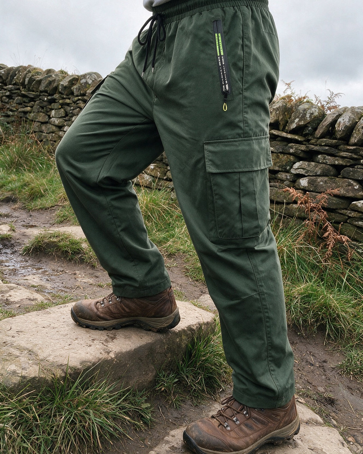 Hartley cargo trousers in Olive Green stepping up on a countryside footpath