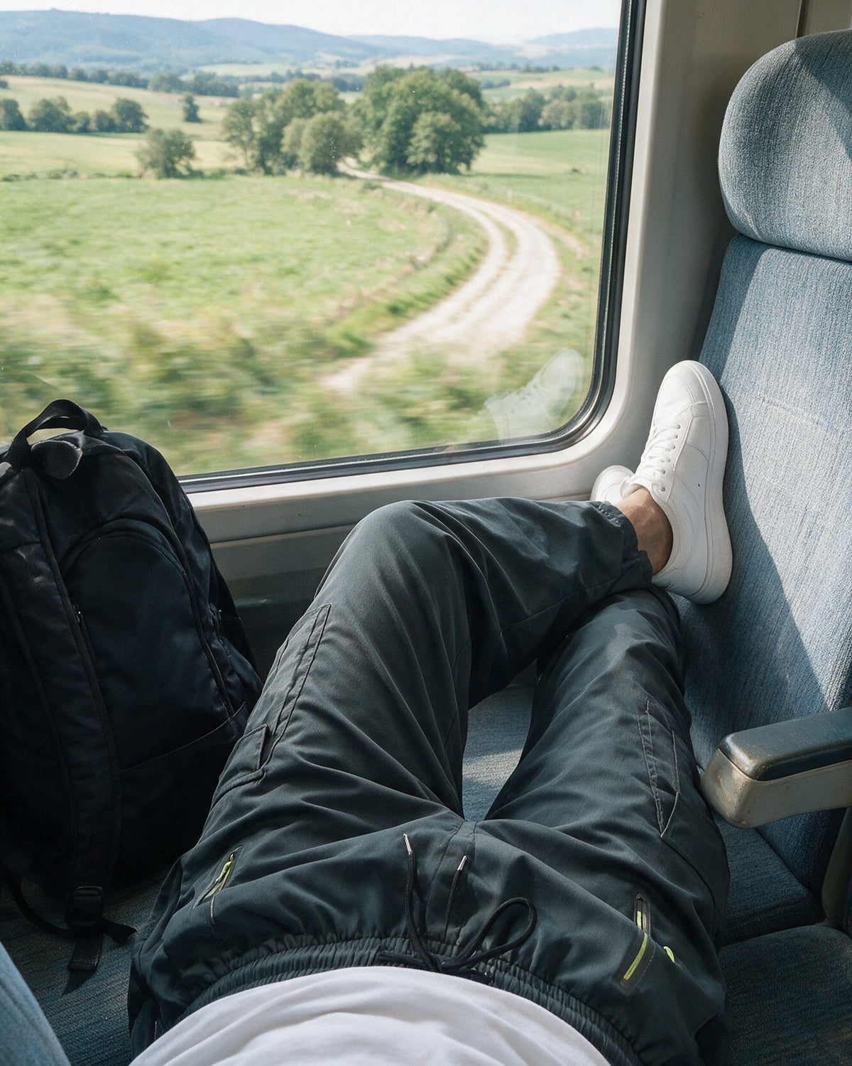 Hartley cargo trousers in Dark Gray on a train journey