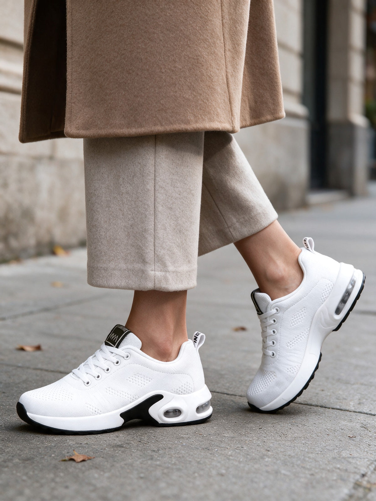 White OrthoCare sneakers walking on a city sidewalk